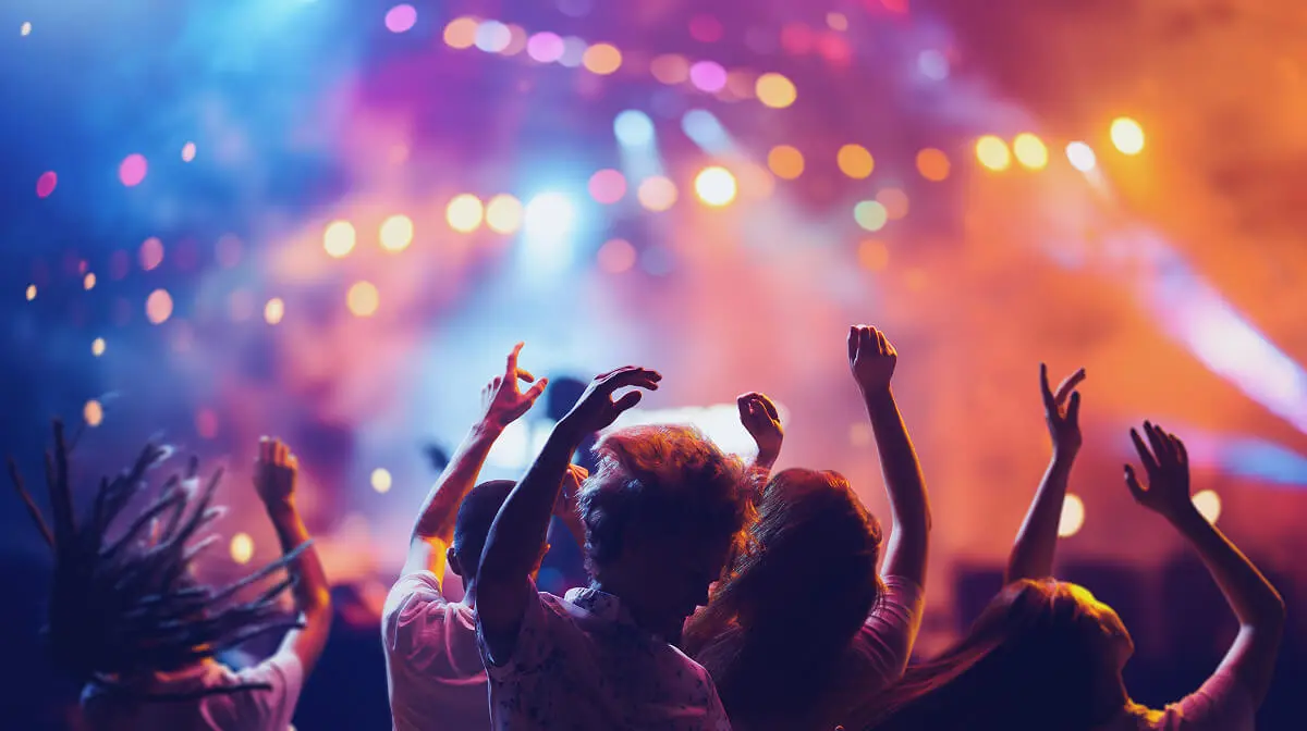 People dancing at a vibrant music concert.