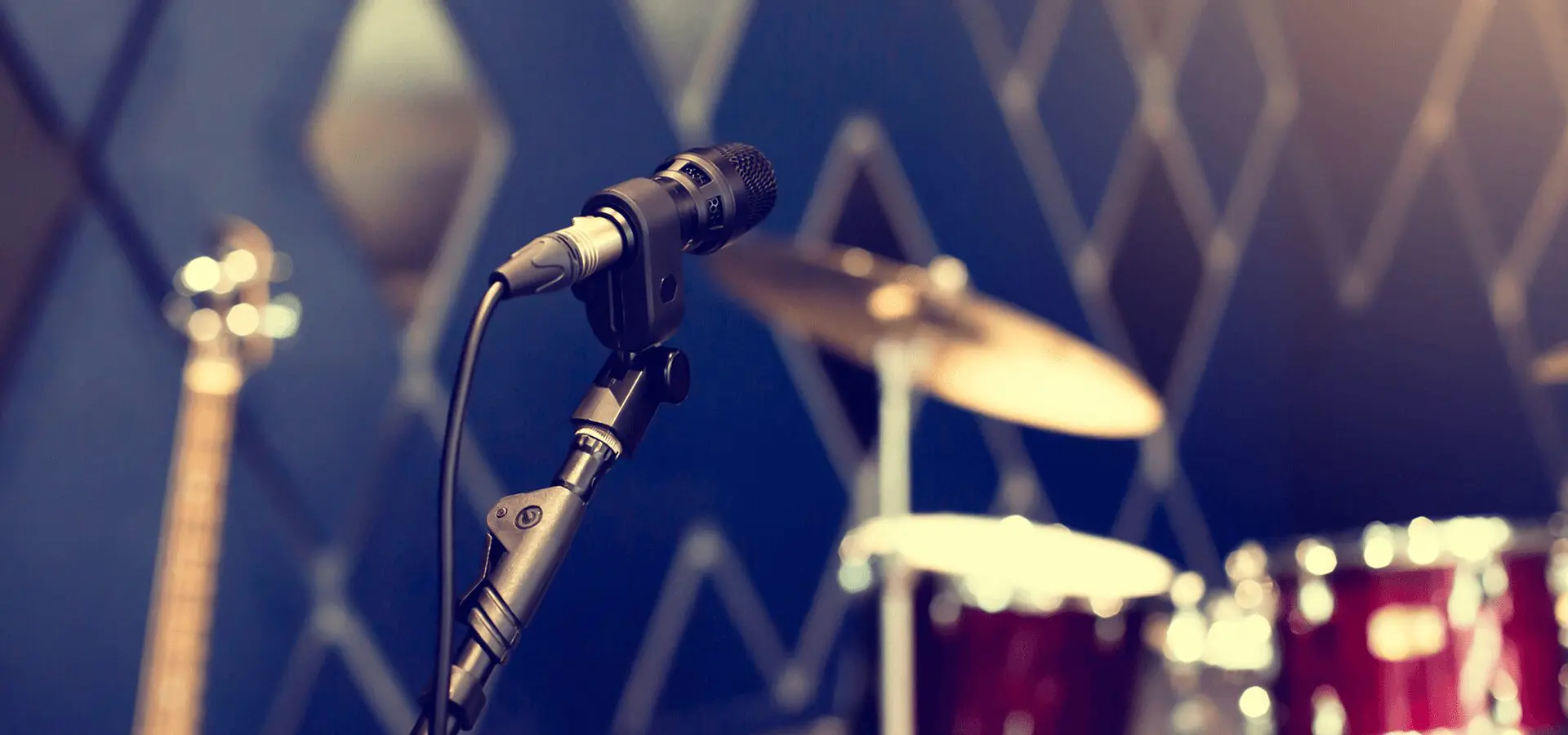 Microphone and drum set in studio.