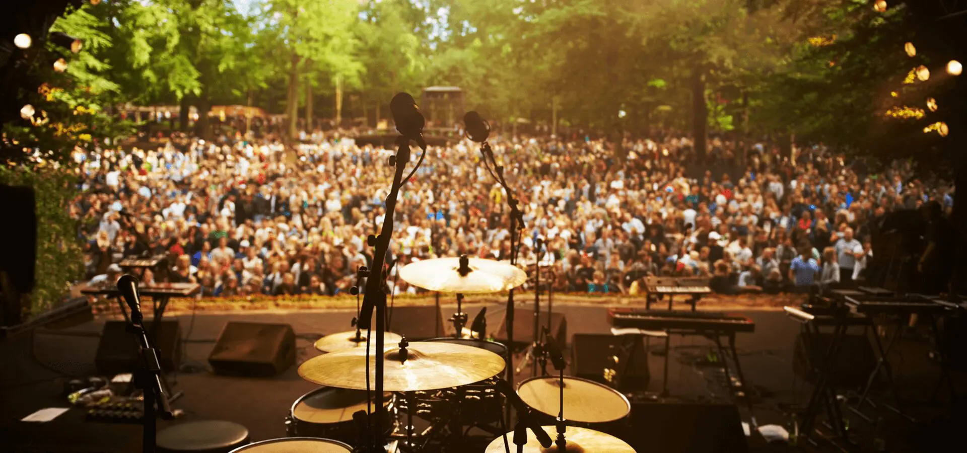 Outdoor concert stage with large audience.