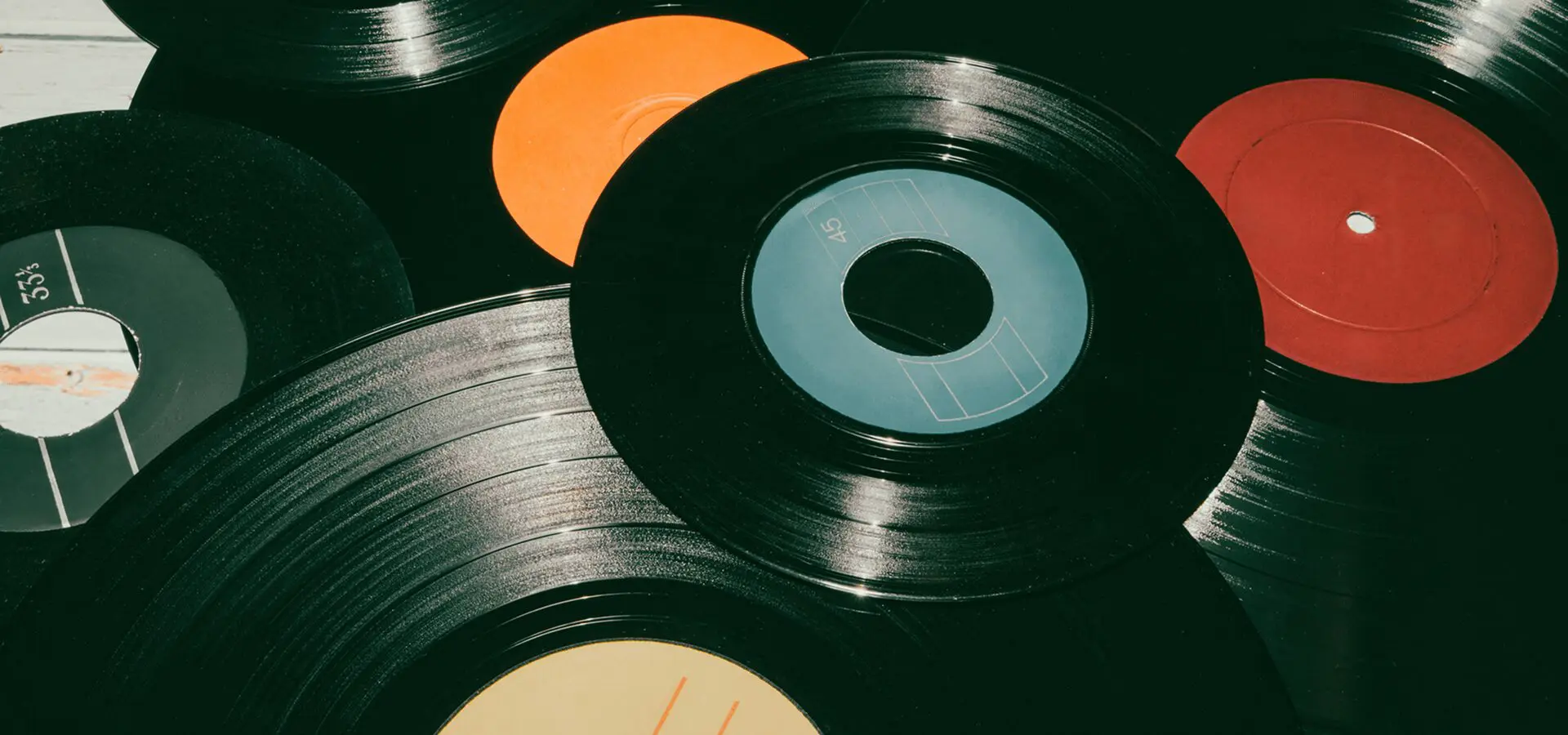 Vinyl records with colorful labels scattered.