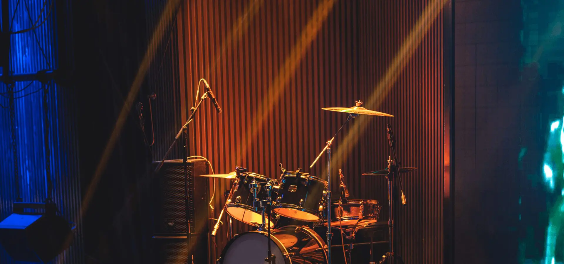 Empty stage with drum set and lights.
